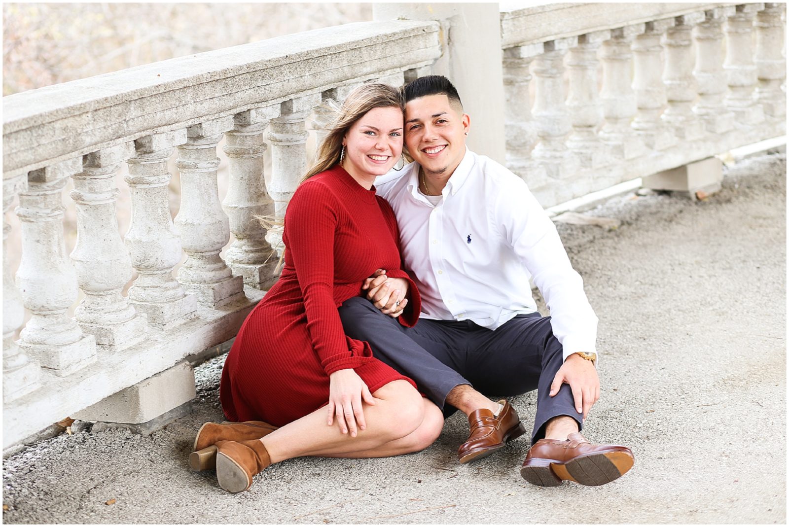 CUTE COUPLE SITTING DOWN FOR ENGAGEMENT PORTRAITS - KANSAS CITY WEST BOTTOMS ENGAGEMENT PORTRAITS WITH MARIAM SAIFAN PHOTOGRAPHY - BEST WEDDING PHOTOGRAPHER IN KC - KANSAS CITY PORTRAIT AND WEDDING PHOTOGRAPHER - WEDDING AT BARN AT RIVERBEND