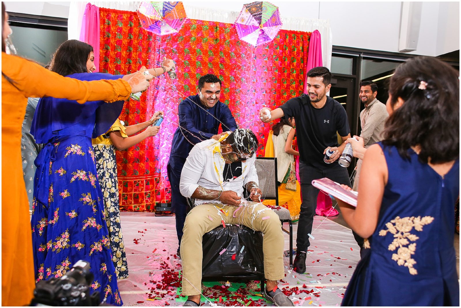 confetti and spray groom indian wedding Indian Pakistani Wedding Hennah Party in Olathe Eagles Landing - Kansas City Indian Wedding Photographer