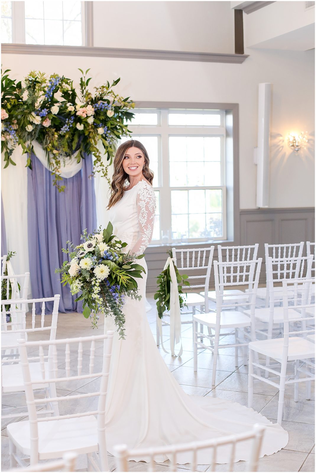 THE FIELDS AT 1890 - 1890 EVENT SPACE - WEDDINGS AT 1890 IN KANSAS CITY - BRIDE AT ALTAR WITH BEAUTIFUL BLUE AND WHITE AND GREEN WEDDING FLOWERS AND BOUQUET - LONG SLEEVE LACE WEDDING DRESS - KANSAS CITY BASED DESTINATION PORTRAIT AND WEDDING PHOTOGRAPHER MARIAM SAIFAN PHOTOGRAPHY - KANSAS CITY WEDDING FLORISTS