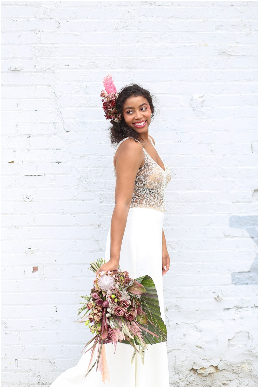 BEAUTIFUL LAUGHING BRIDE AT THE HAVANA ROOM IN KANSAS CITY WITH A TROPICAL WEDDING BOUQUET - TROPICAL WEDDING INSPIRATION - ALL PHOTOS ARE BY MARIAM SAIFAN PHOTOGRAPHY - KANSAS CITY BASED AND DESTINATION WEDDING PHOTOGRAPHER
