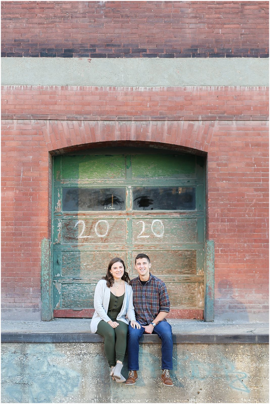 couple sitting engagement photos - Avery and Jack Engagement Session - Kansas City West Bottoms Engagement Portraits - KC Wedding Photographer - Olathe Lenexa Leawood Kansas Wedding Photography and Video  - Mariam Saifan Photography 