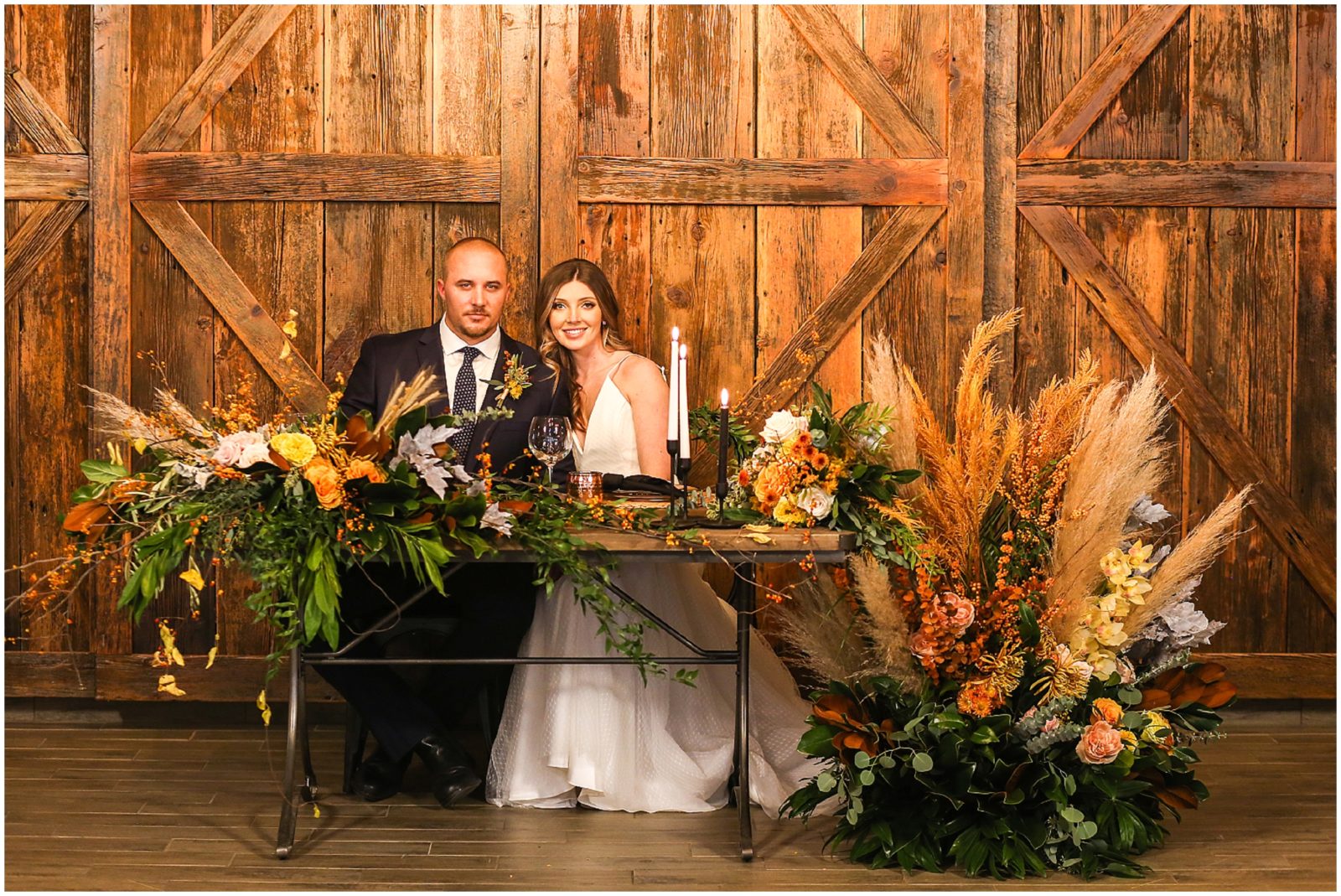 The Barn at Riverbend - Barn wedding IN KANSAS CITY - BRIDE AND GROOM AT HEAD TABLE 