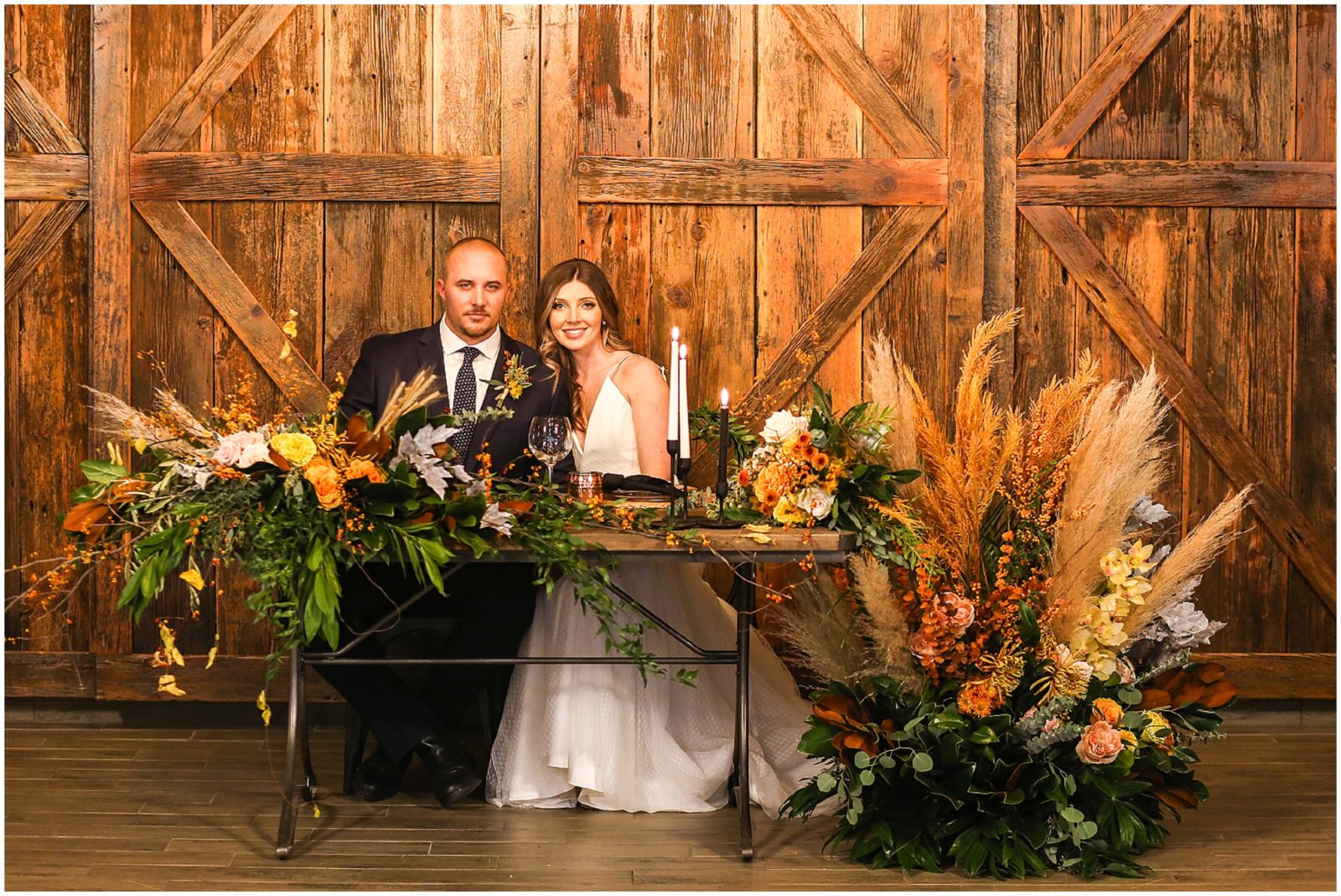The Barn at Riverbend - Barn wedding IN KANSAS CITY - BRIDE AND GROOM AT HEAD TABLE