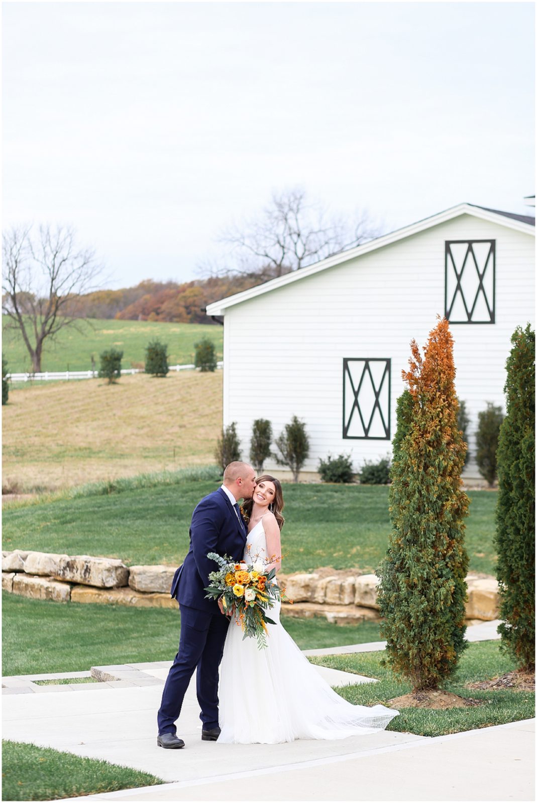 BRIDE AND GROOM AT THE FIELDS AT 1890 FALL THEMED WEDDING