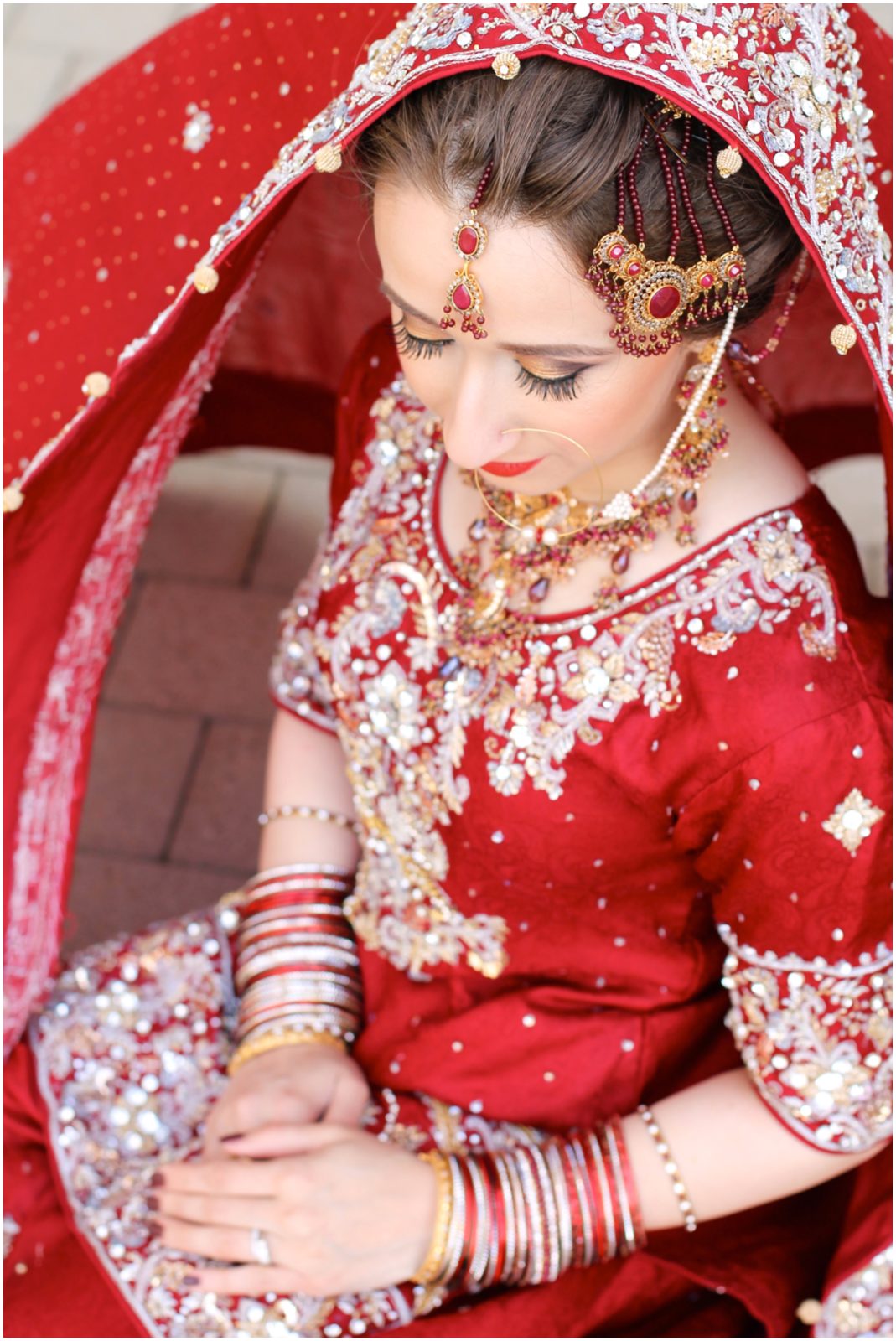indian bride with red vibrant wedding outfit and kauffman center 