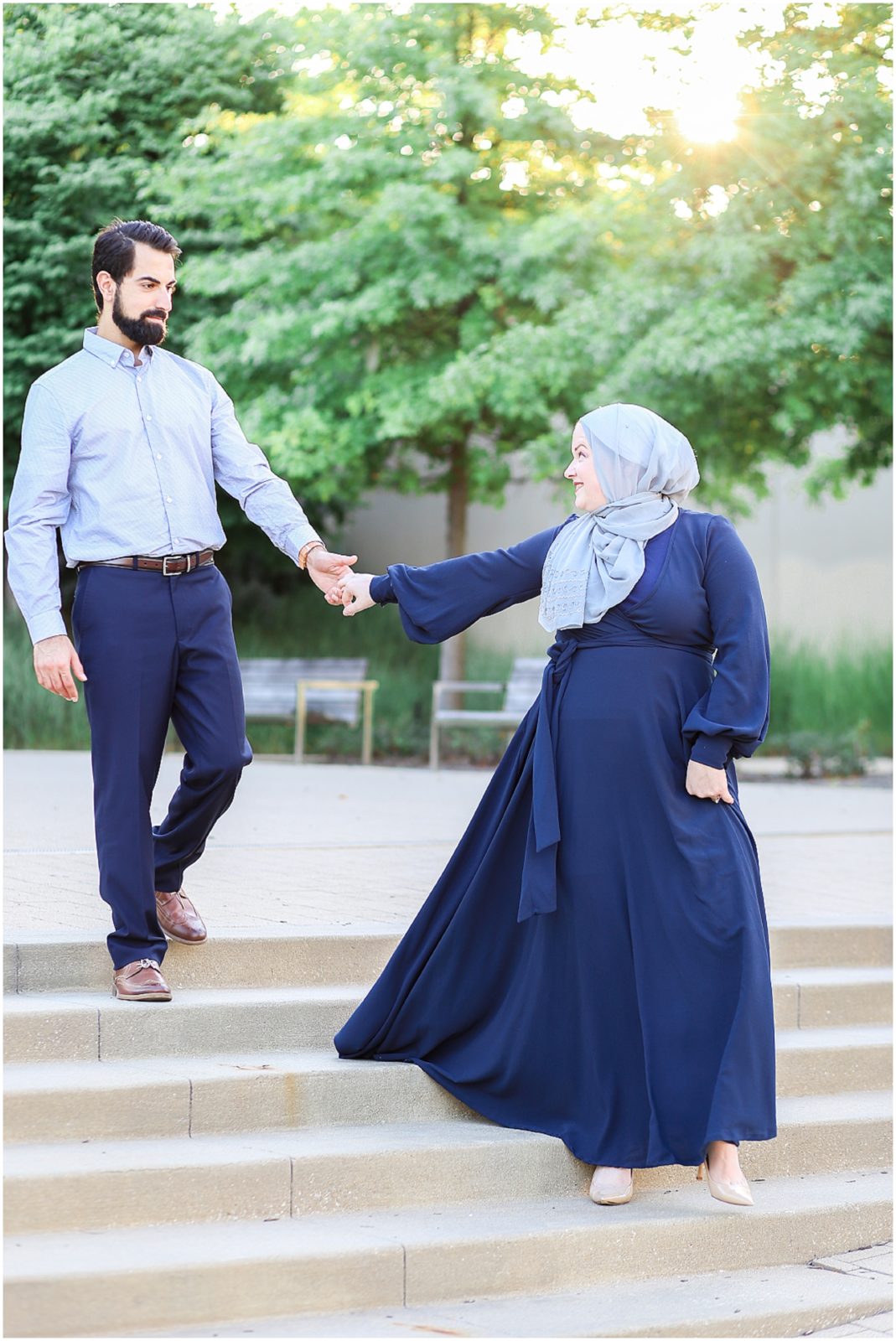 couple walking down the stairs posing - Kauffman Center of Performing Arts Anniversary Session | Kansas City Crossroads Portraits and Engagement Session | Best Kansas City Portrait and Wedding Photographer | Wedding Photography by Mariam Saifan Photography | Wedding and Engagement Photo Locations in the Kansas City Area