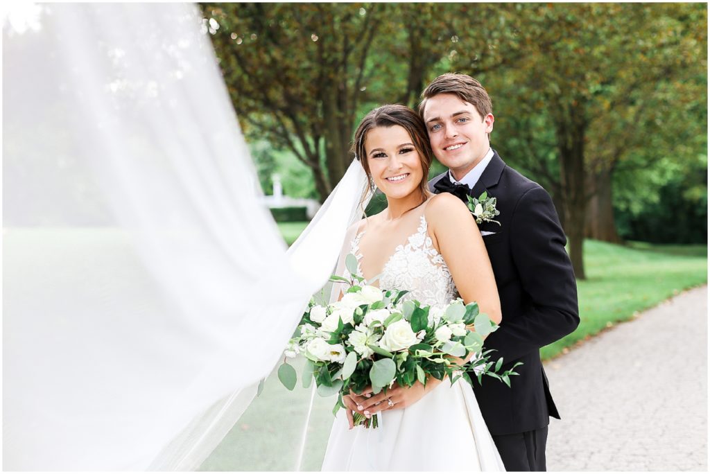 beautiful bride and groom with wedding veil taken at the Hawthorne House wedding venue