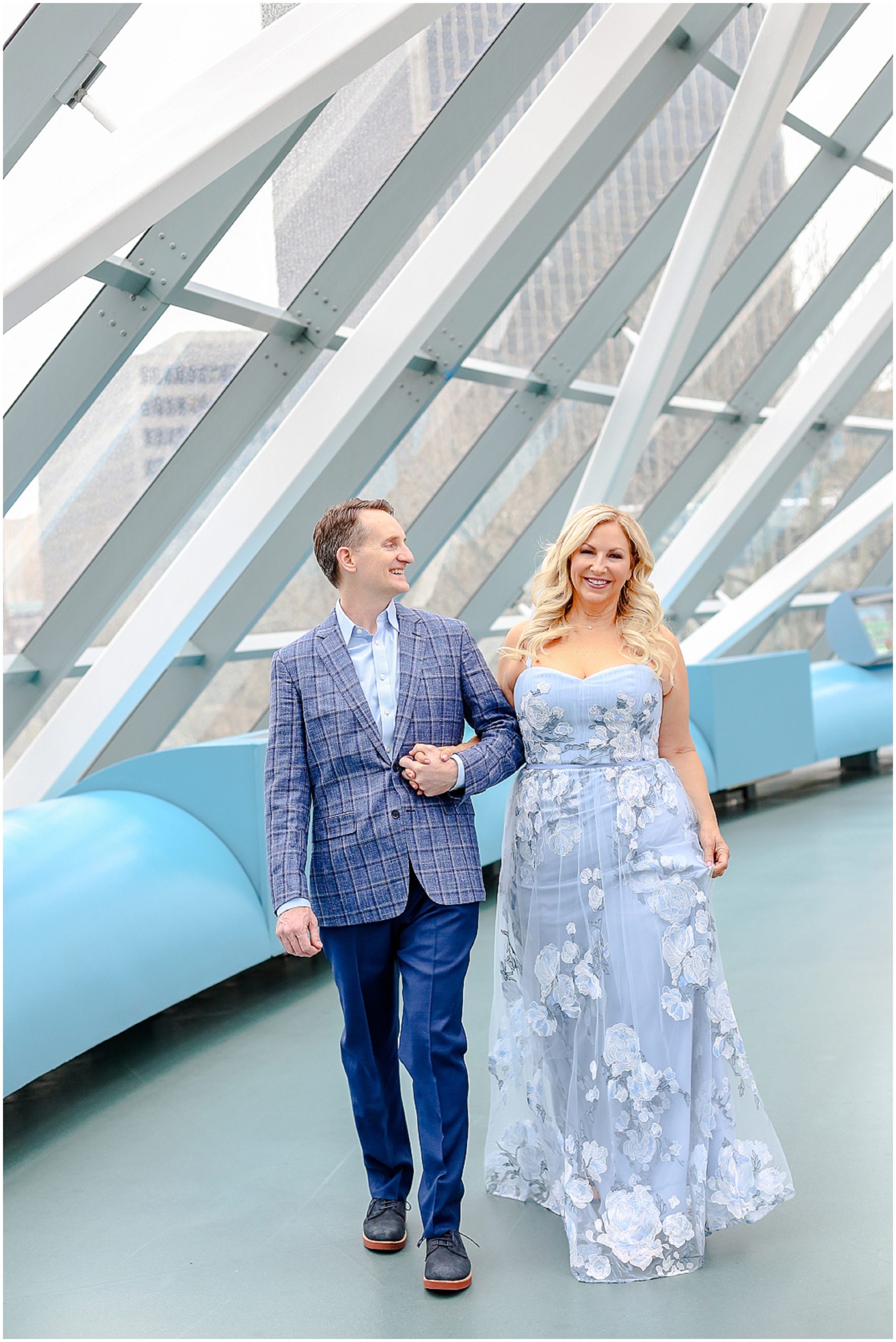happy engaged couple for their engagement portraits in kansas city - liberty memorial - crown center
