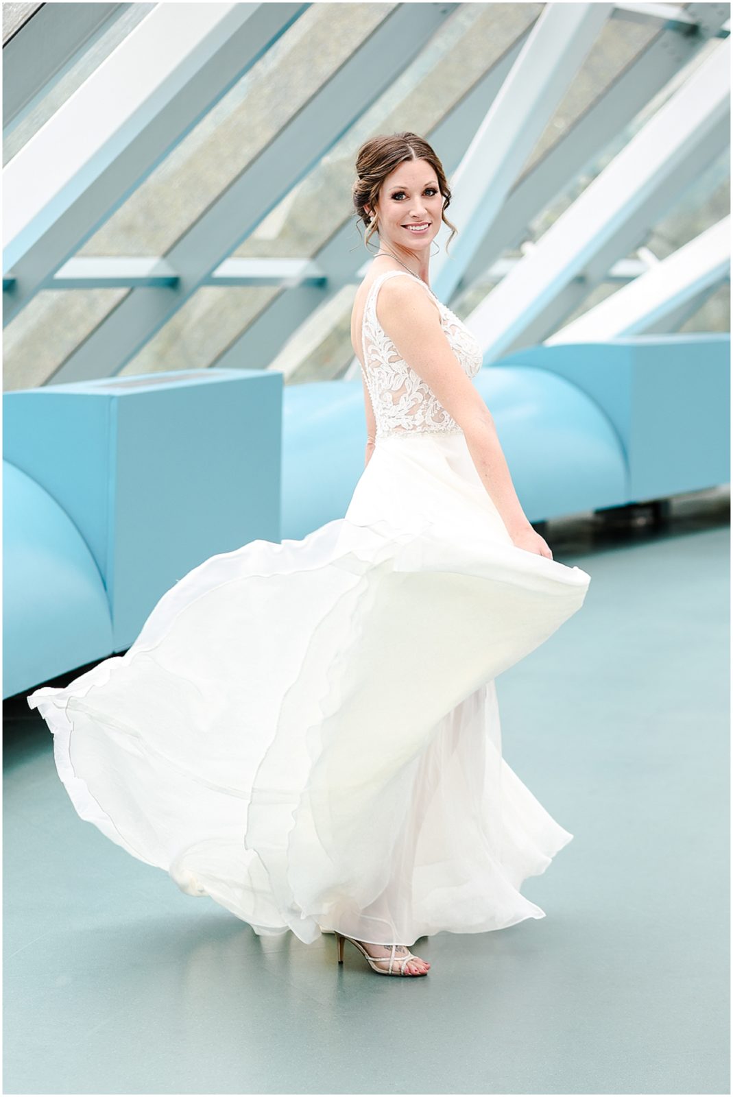 bride twirling in her wedding dress - Westin Crown Center Wedding Photos in Kansas City