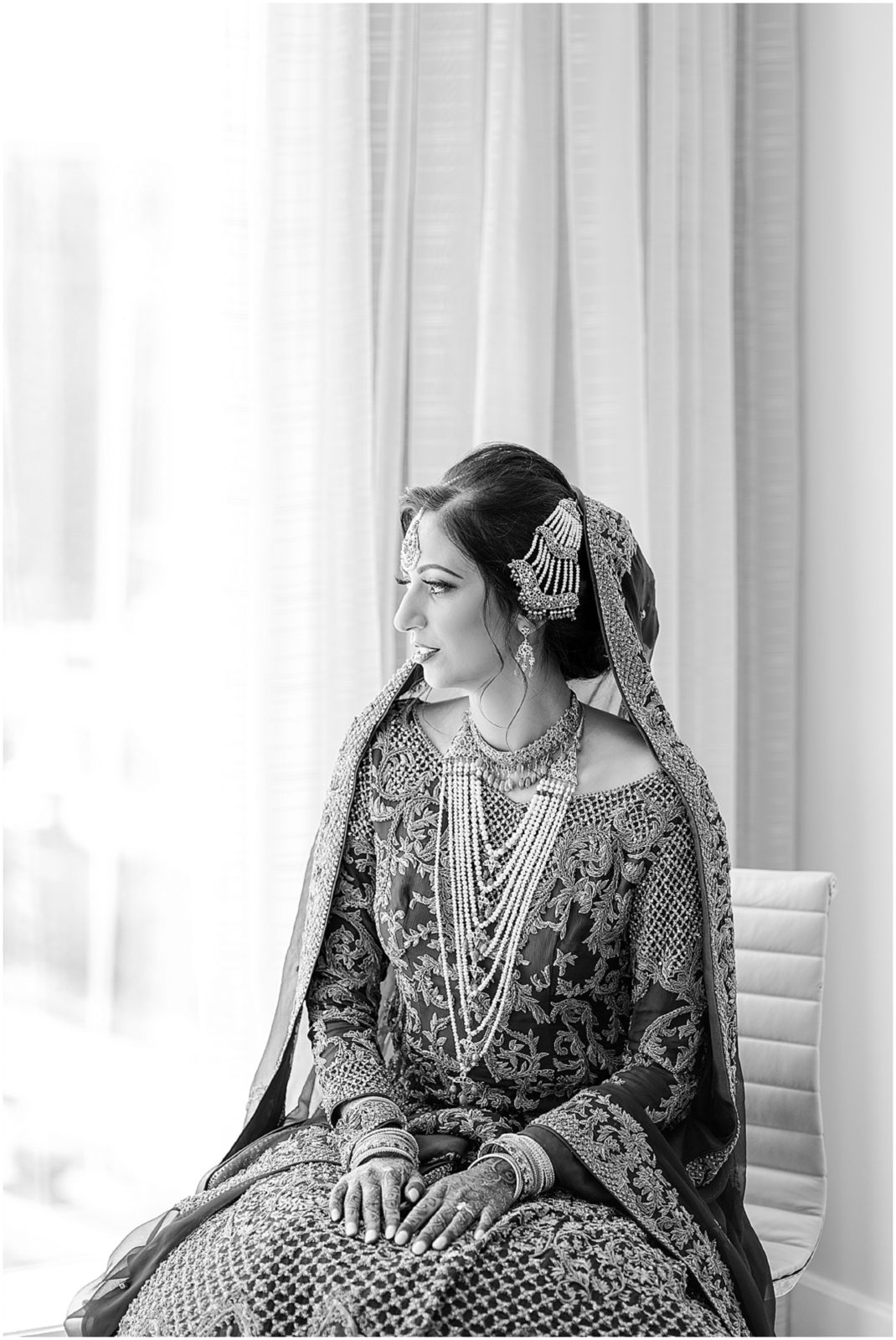 indian bride looking out the window at the st louis archway - four seasons hotel wedding - kansas city wedding photographer 