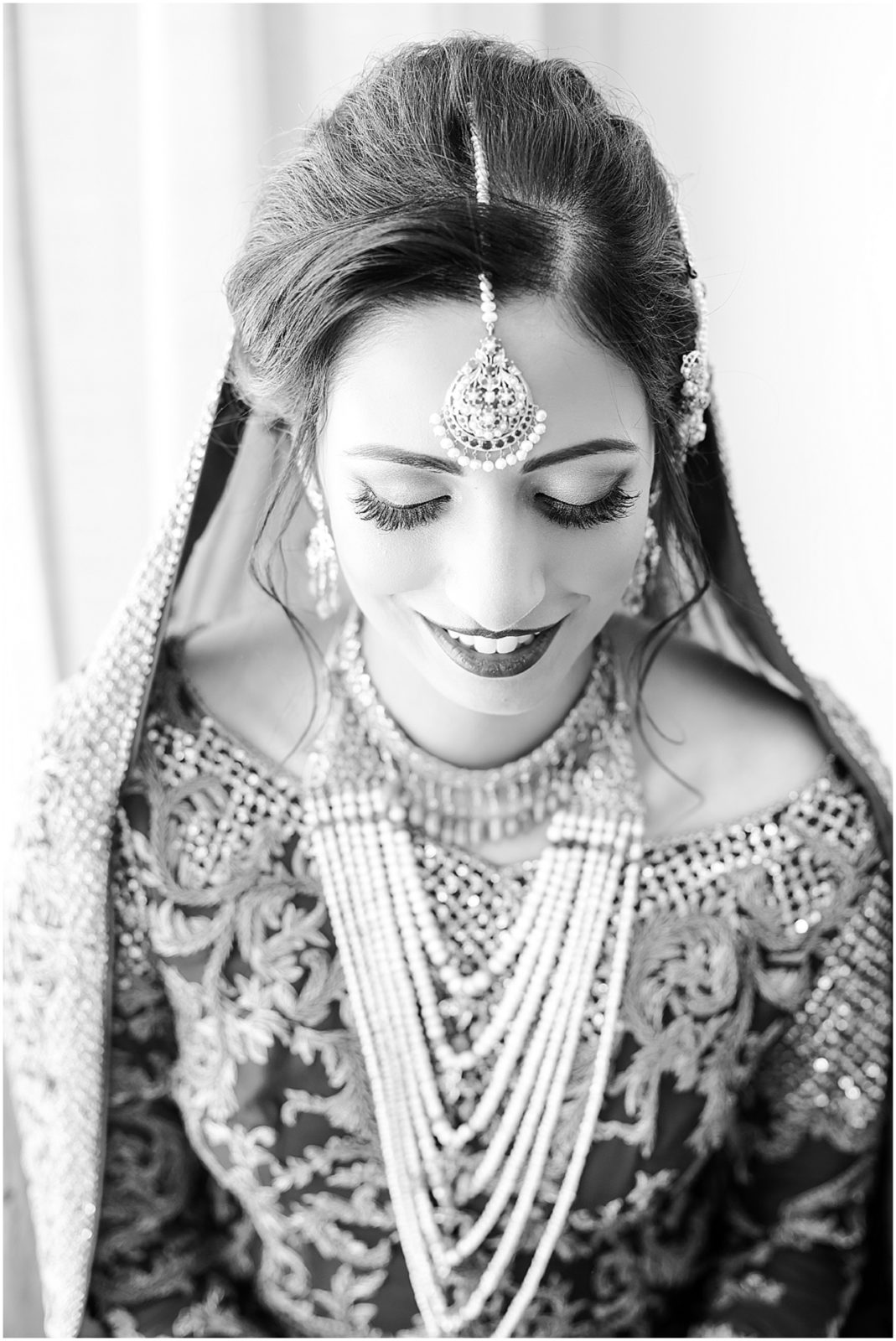 beautiful indian bride looking down for wedding photos with mariam saifan photography