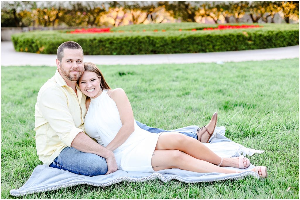 engagement portrait laying on the grass at nelson atkins kansas city