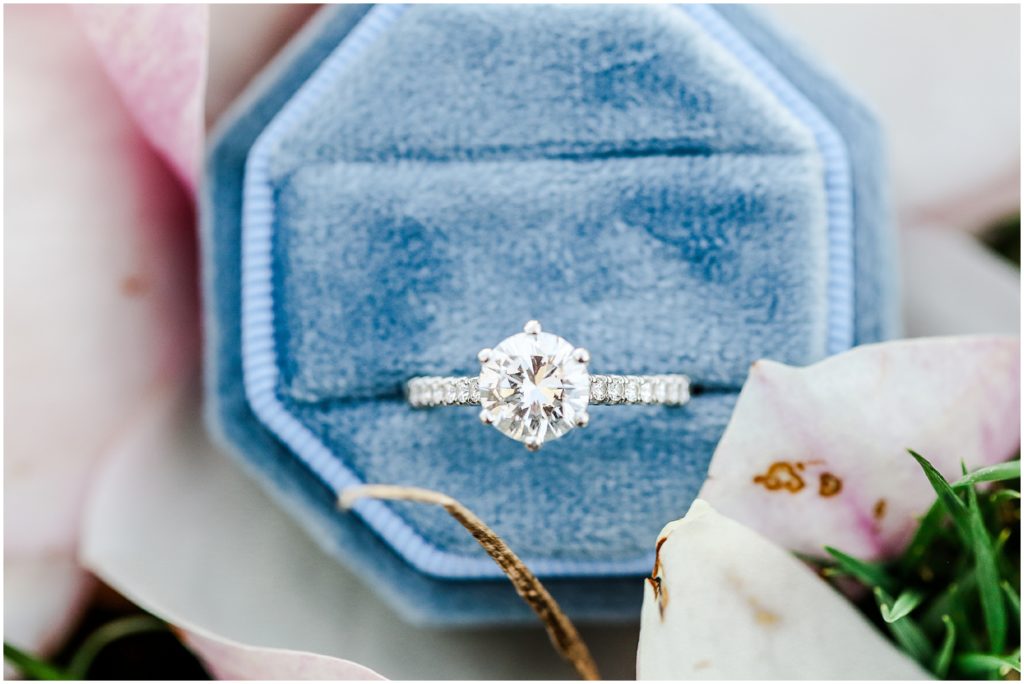 blue ring box with diamond engagement ring