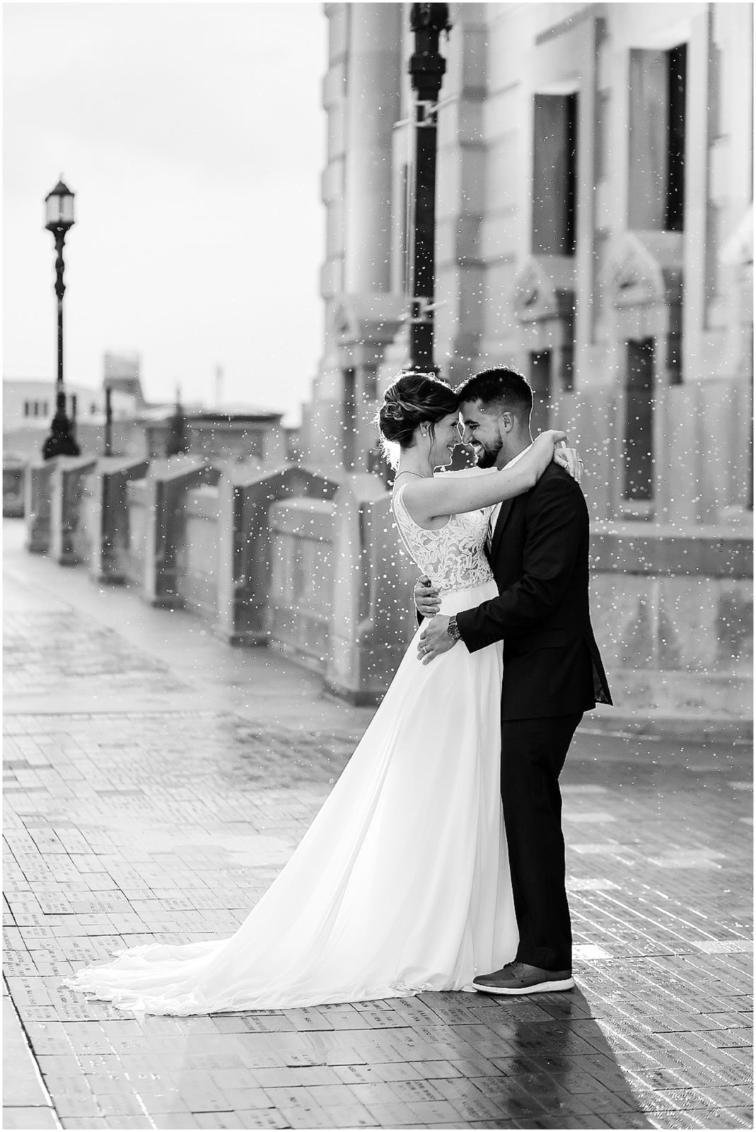 black and white photo in the rain of wedding couple