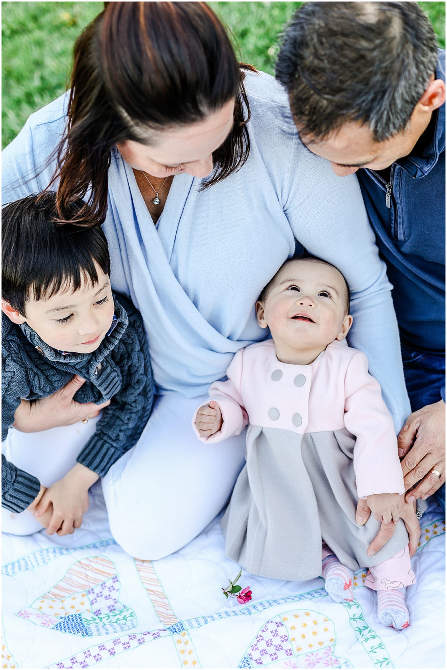 baby looking up at family for their photos