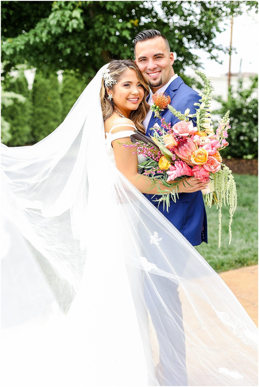 Gorgeous Bride & Groom Wedding Photos taken at the Kansas City Wedding Venue - Rhapsody - by Mariam Saifan Photography - Long Wedding Veil - Lace Wedding Dress - Tropical Wedding Theme