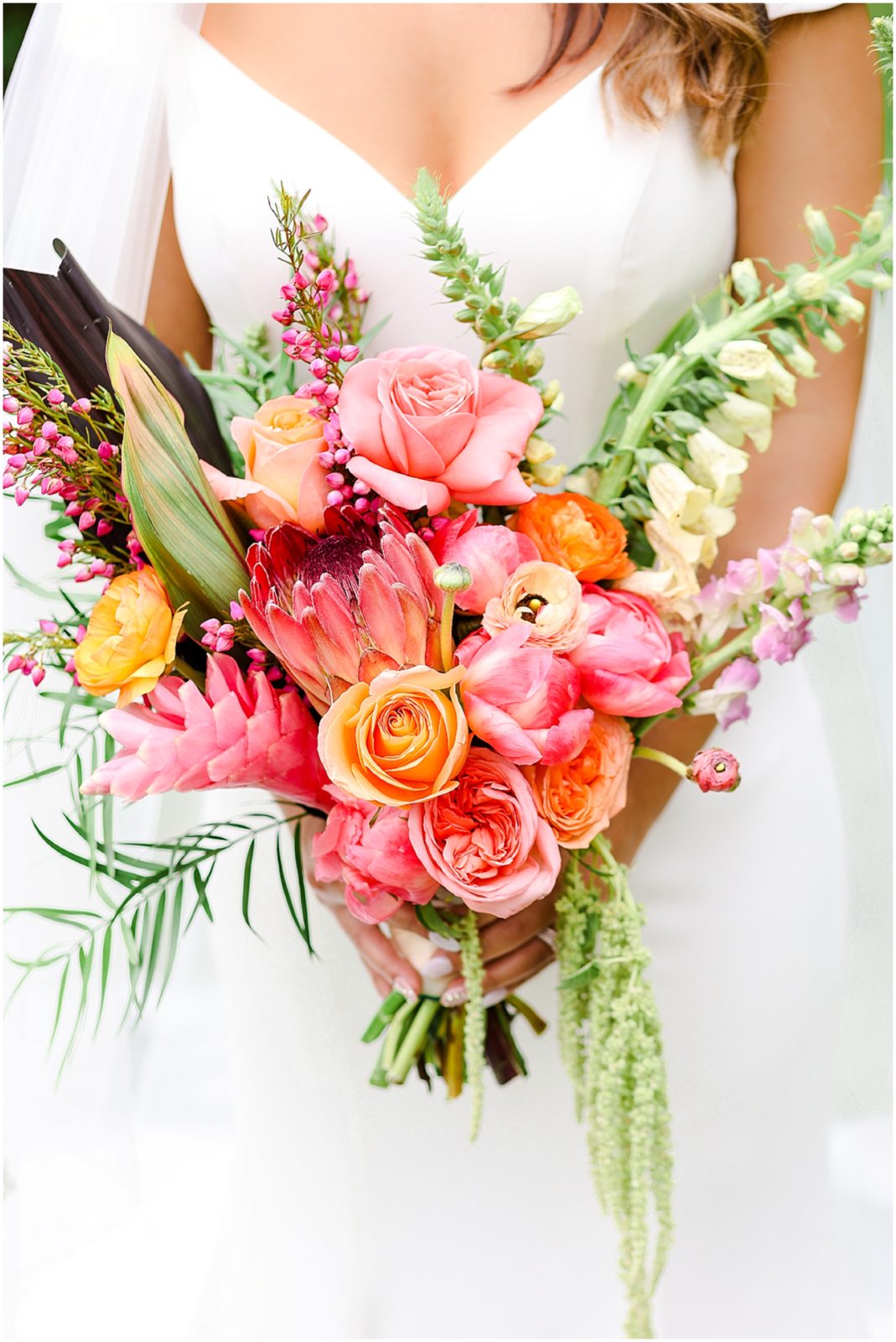 pink orange and beautiful tropical wedding bouquet 

Gorgeous Bride & Groom Wedding Photos taken at the Kansas City Wedding Venue - Rhapsody - by Mariam Saifan Photography - Long Wedding Veil - Lace Wedding Dress - Tropical Wedding Theme