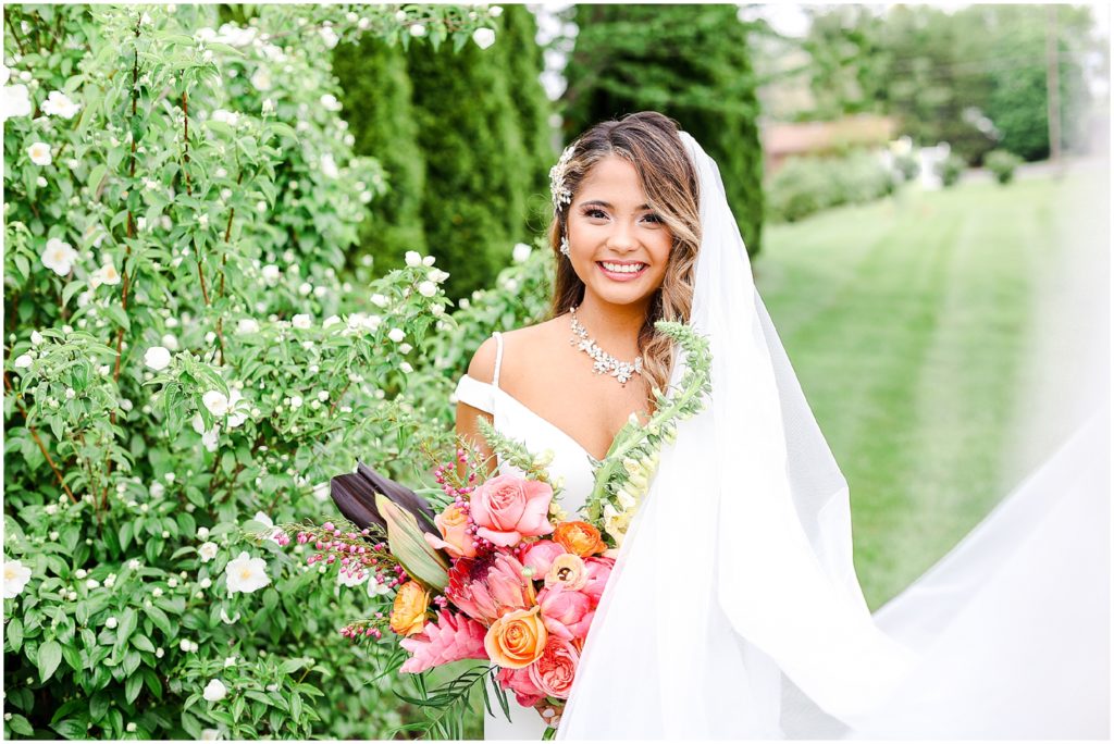 Gorgeous Bride & Groom Wedding Photos taken at the Kansas City Wedding Venue - Rhapsody - by Mariam Saifan Photography - Long Wedding Veil - Lace Wedding Dress - Tropical Wedding Theme with beautiful bride