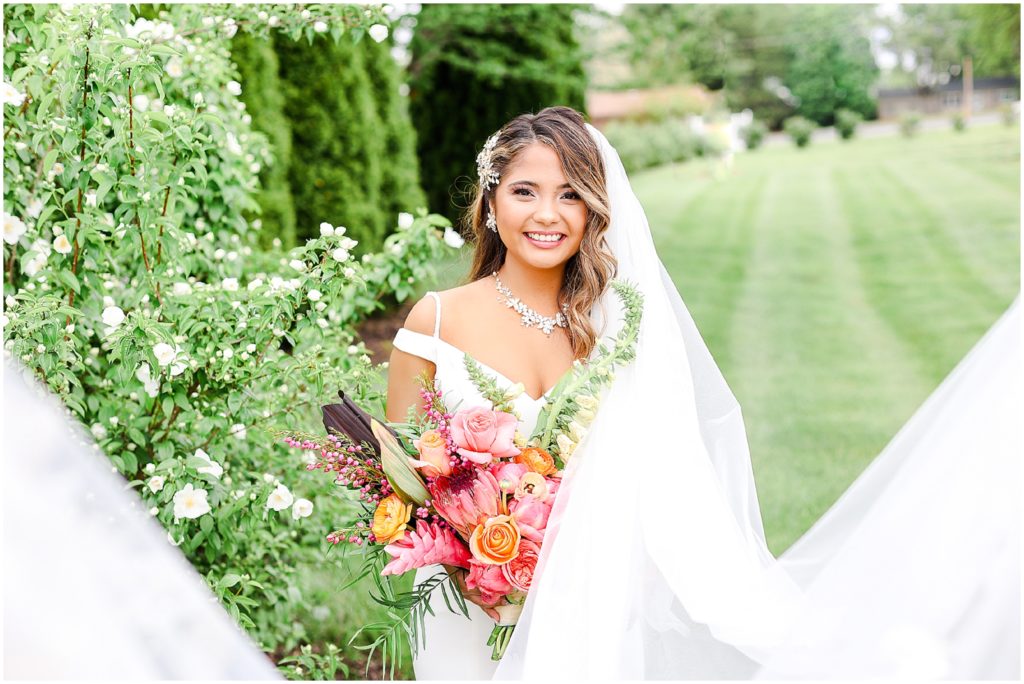 Gorgeous Bride & Groom Wedding Photos taken at the Kansas City Wedding Venue - Rhapsody - by Mariam Saifan Photography - Long Wedding Veil - Lace Wedding Dress - Tropical Wedding Theme