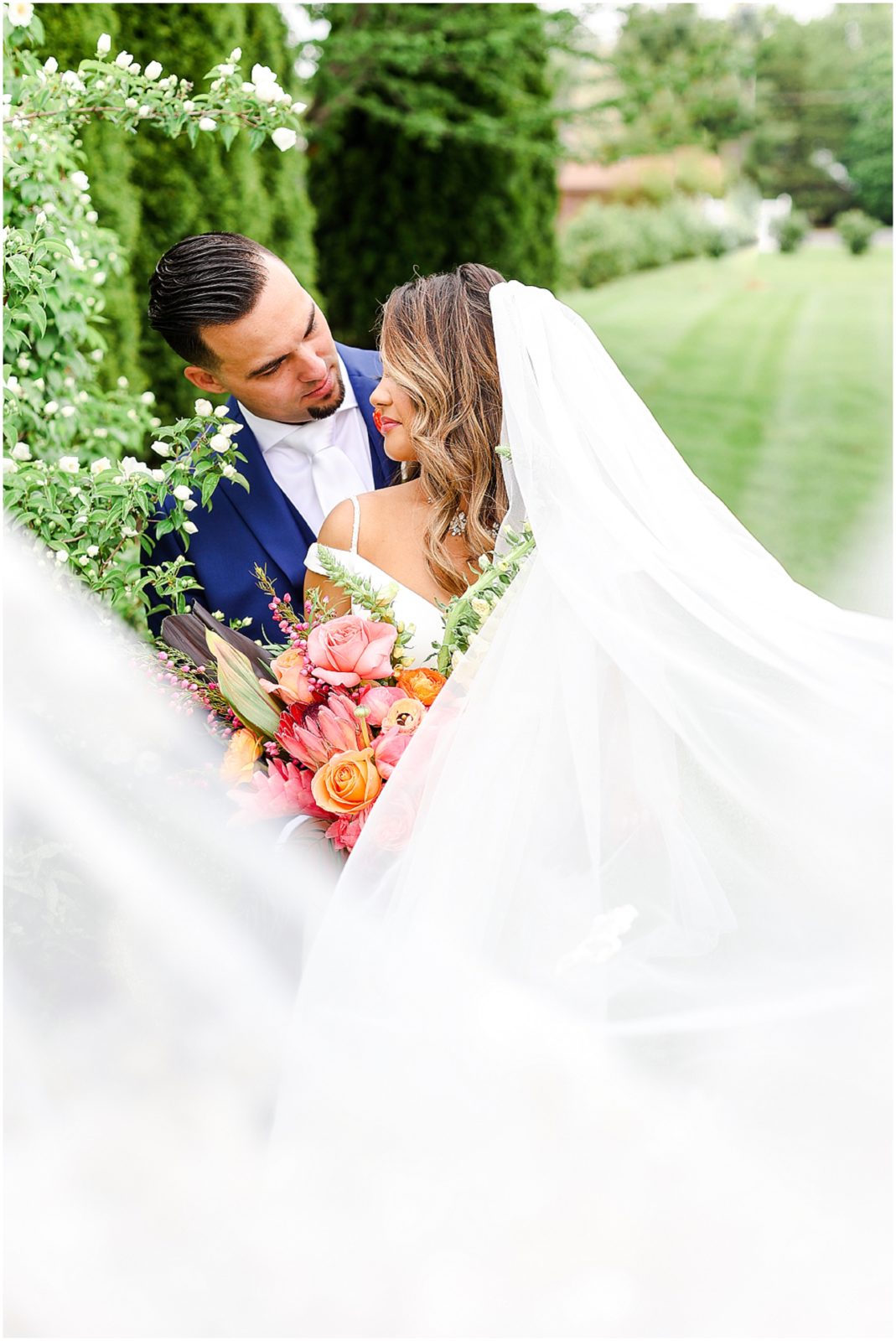 wedding veil photo - Gorgeous Bride & Groom Wedding Photos taken at the Kansas City Wedding Venue - Rhapsody - by Mariam Saifan Photography - Long Wedding Veil - Lace Wedding Dress - Tropical Wedding Theme