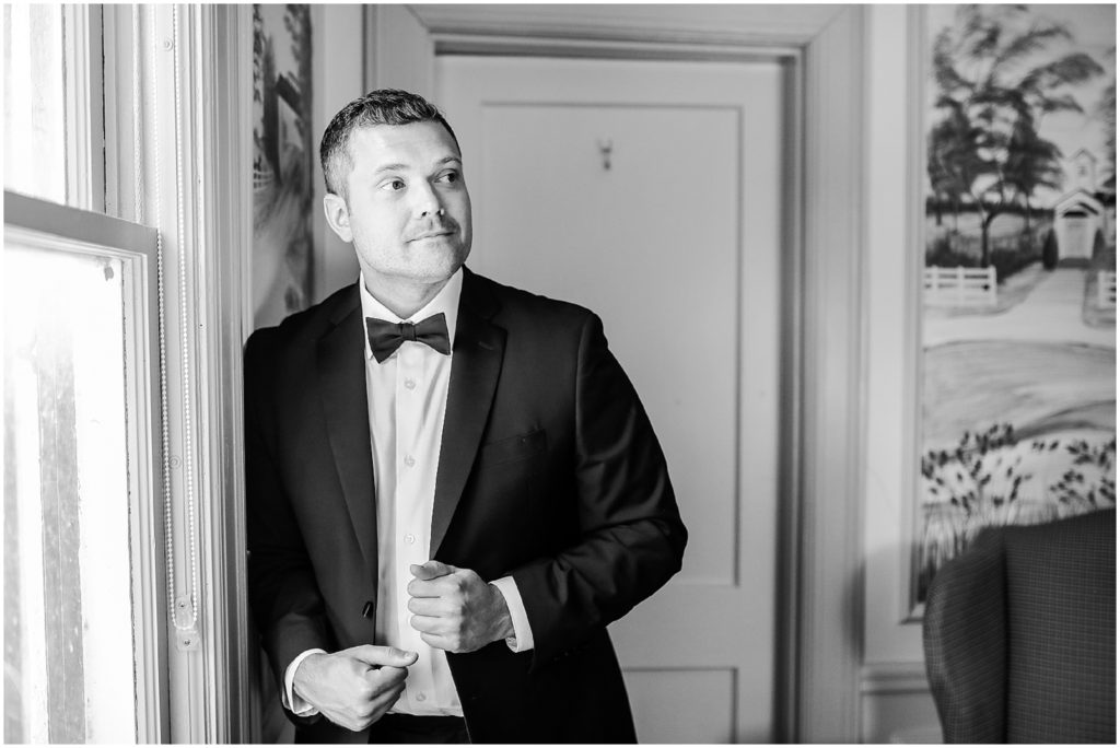 groom getting ready in a tux