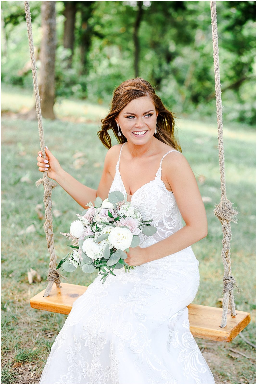 bride sitting on a swing - beautiful wedding photos - barn at river bend - kansas city wedding photographer