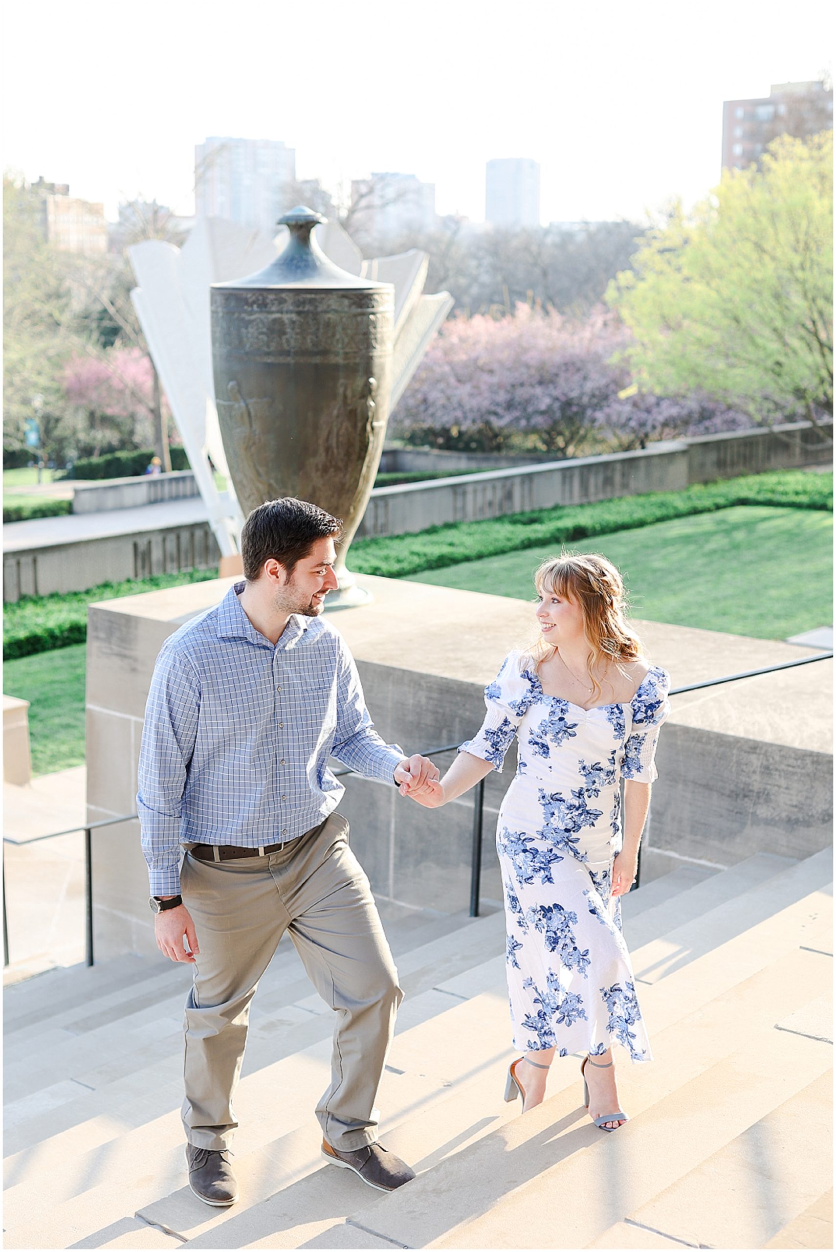 Look at what they wore for their engagement photos! Spring Engagement Photos with Ali & Connor at the Nelson Atkins Museum in Kansas City by best wedding photographer Mariam Saifan Photography - Engagement and Wedding Style Guide - What to Wear and Where to Take Your Photos in Kansas City - walking up the nelson atkins 