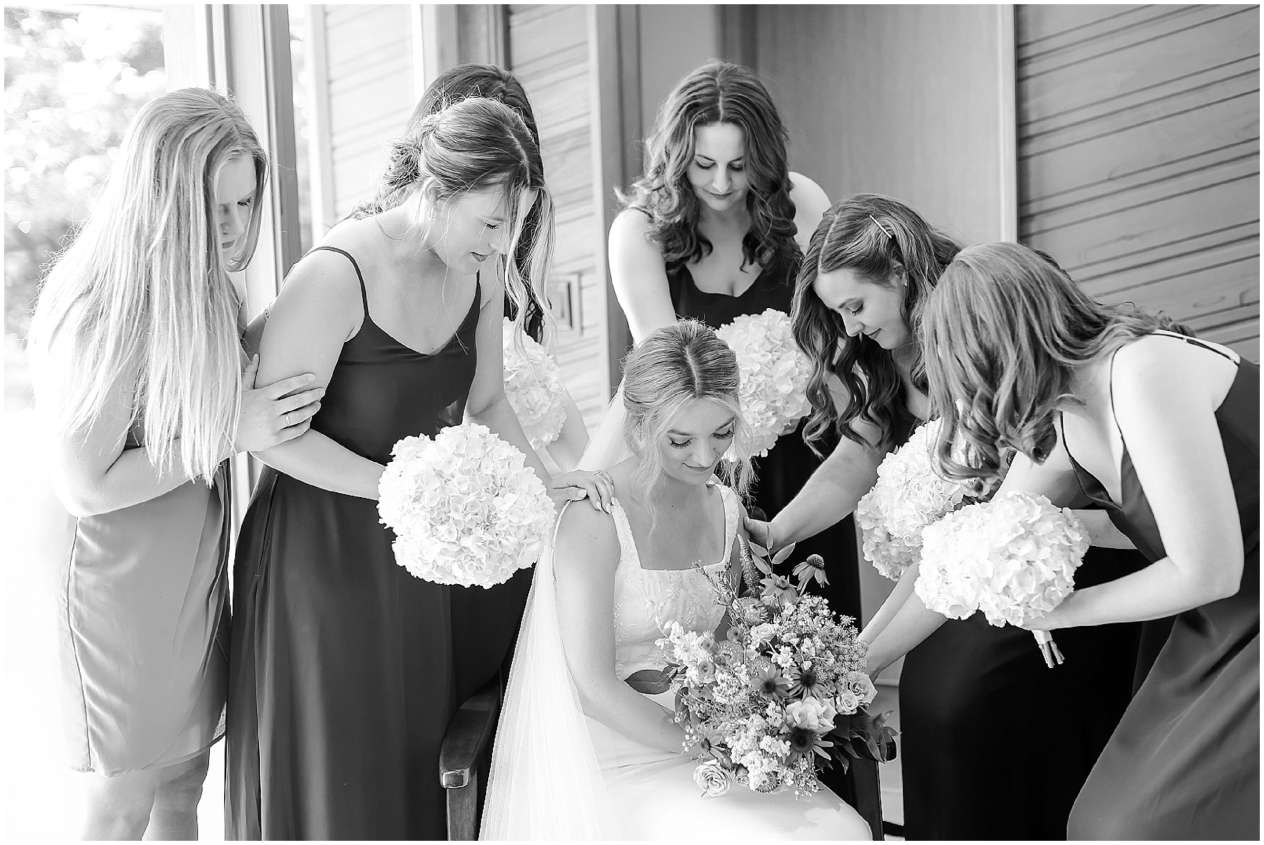 bridesmaids saying a prayer for the bride 