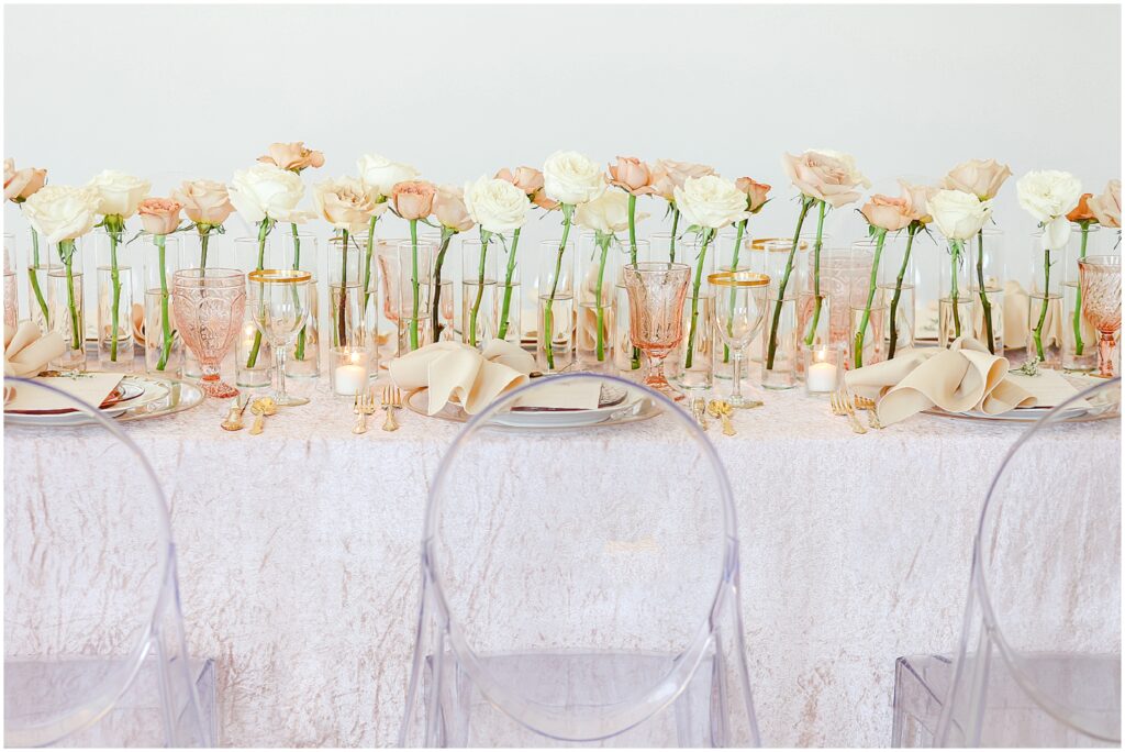 wedding table with pink color accents and roses 