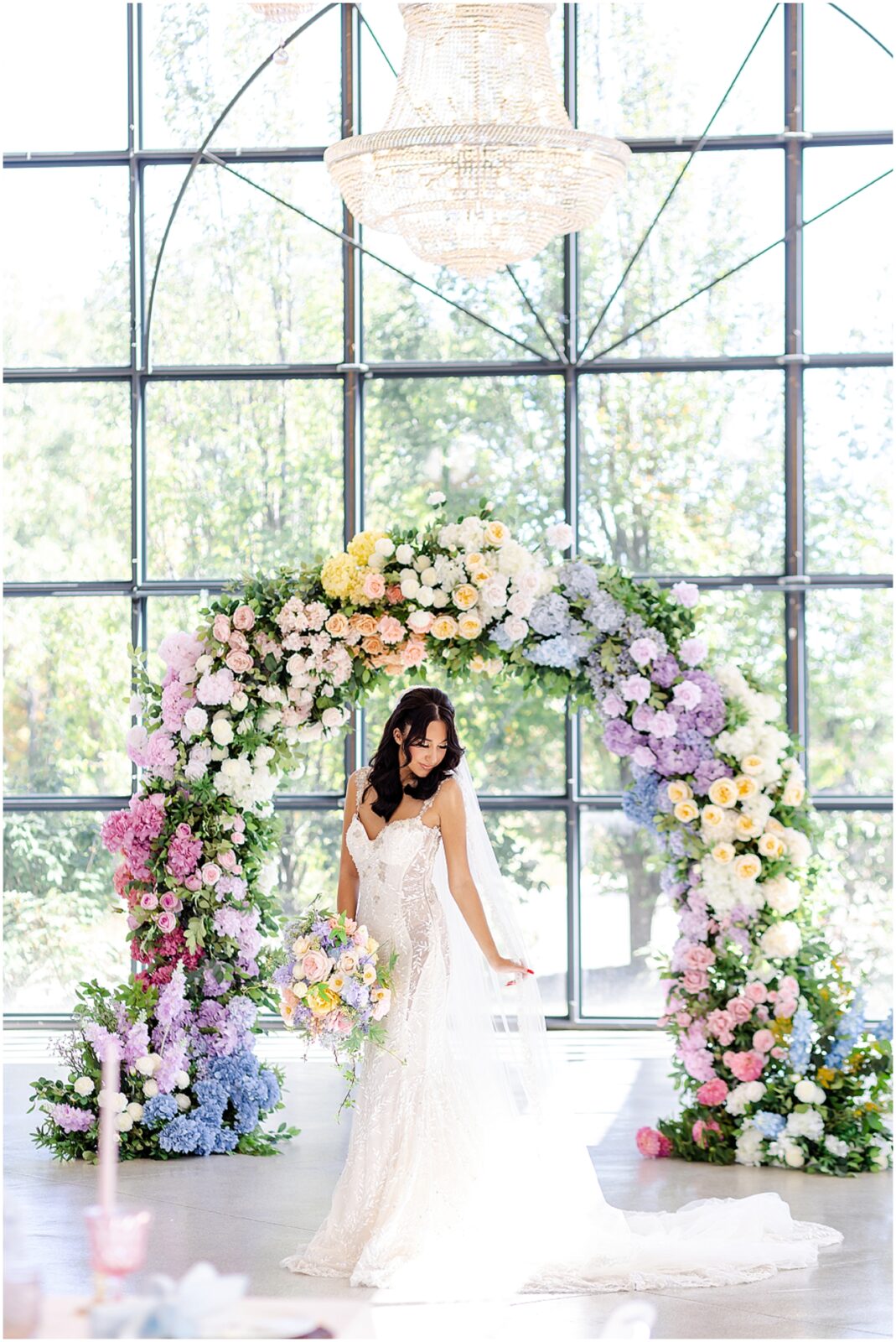 Beautiful colorful flower archway for wedding - lace mermaid wedding gown - wedding design ideas - colorful wedding flowers and wedding photography by Mariam saifan photography - avent orangery wedding photo and film