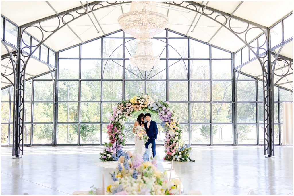 Beautiful colorful flower archway for wedding - lace mermaid wedding gown - wedding design ideas - colorful wedding flowers and wedding photography by Mariam saifan photography - avent orangery wedding photo and film