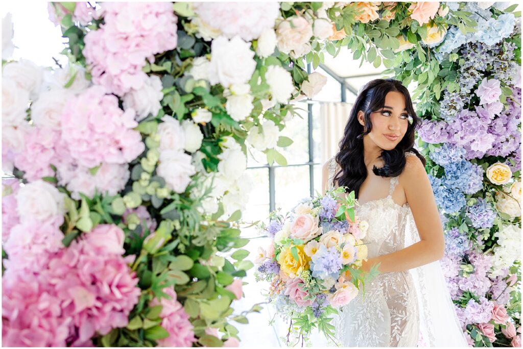 white lace wedding dress with long veil by the One Bridal in kansas city - Mariam Saifan Photography - luxury wedding photography based in KC and STL 30A Florida - Colorful pink flower arch for wedding - italian wedding theme - garden wedding theme  - avent orangery - hair by ezoza 