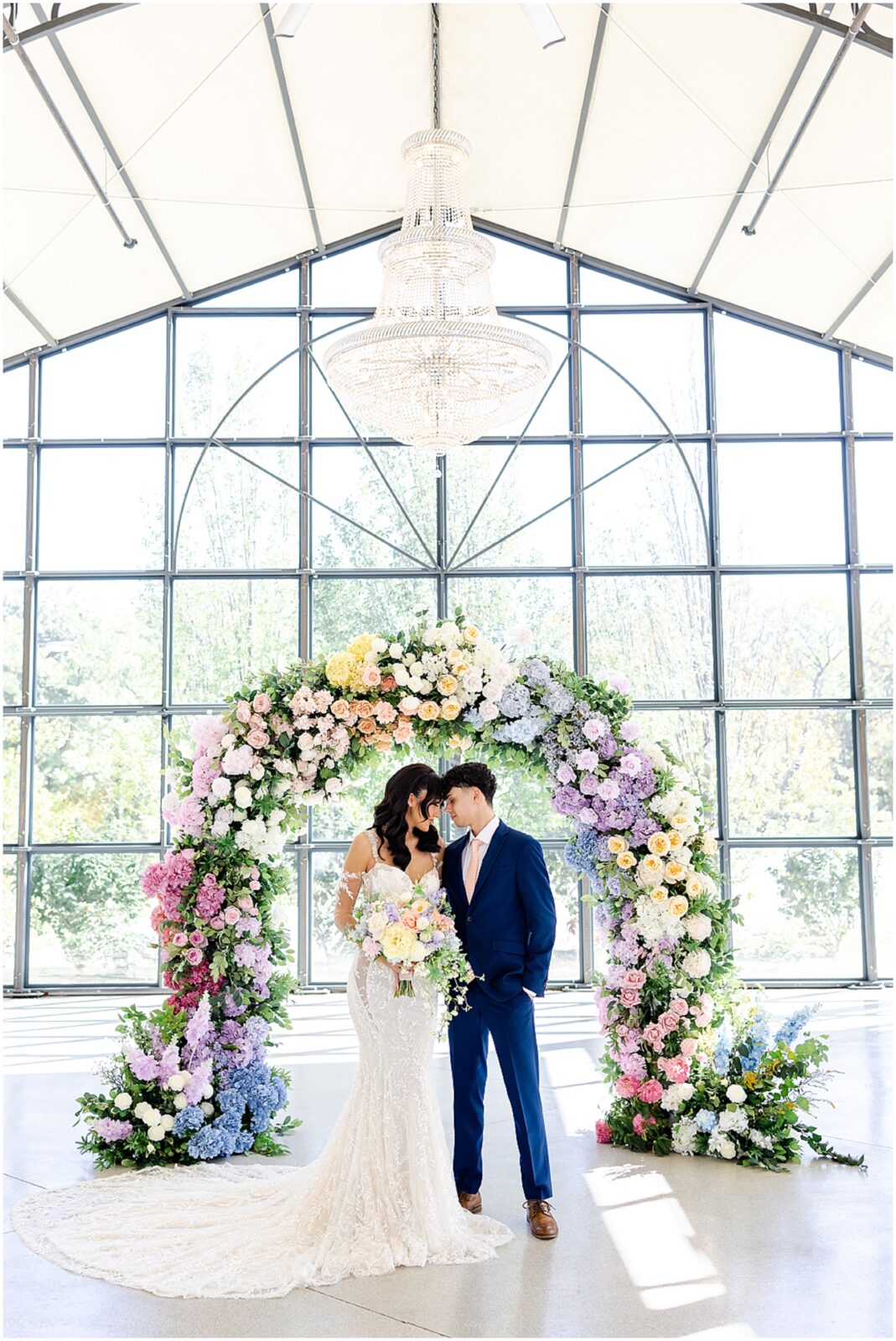 white lace wedding dress with long veil by the One Bridal in kansas city - Mariam Saifan Photography - luxury wedding photography based in KC and STL 30A Florida - Colorful pink flower arch for wedding - italian wedding theme - garden wedding theme  - avent orangery - hair by ezoza 