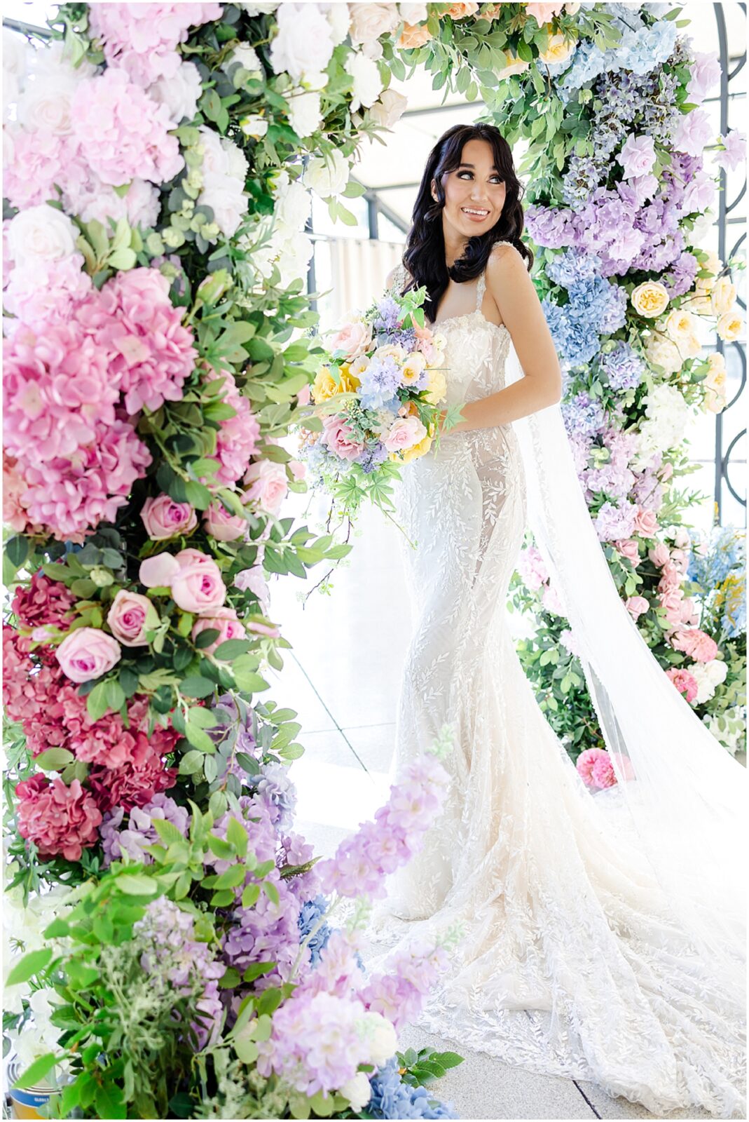 white lace wedding dress with long veil by the One Bridal in kansas city - Mariam Saifan Photography - luxury wedding photography based in KC and STL 30A Florida - Colorful pink flower arch for wedding - italian wedding theme - garden wedding theme  - avent orangery - hair by ezoza 