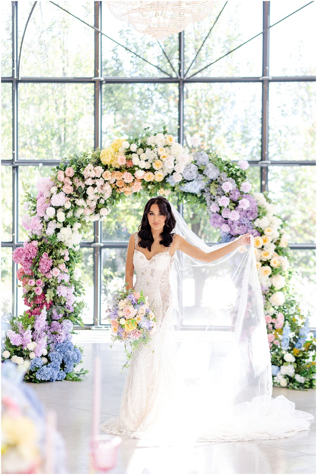 white lace wedding dress with long veil by the One Bridal in kansas city - Mariam Saifan Photography - luxury wedding photography based in KC and STL 30A Florida - Colorful pink flower arch for wedding - italian wedding theme - garden wedding theme  - avent orangery - hair by ezoza 