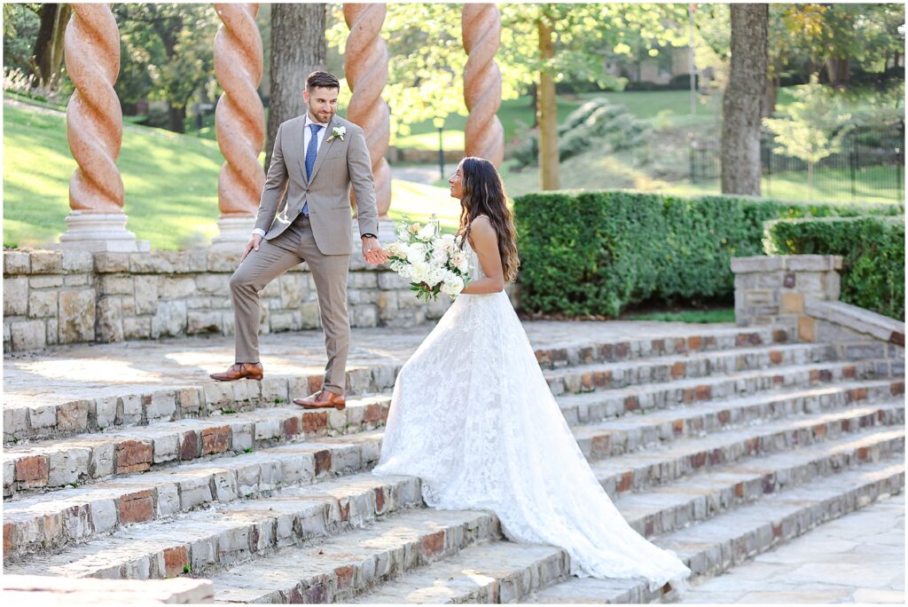 bride and groom walking up for outdoor photos 